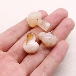 Close-up of three polished mini mushroom stones in cream with natural brown veining
