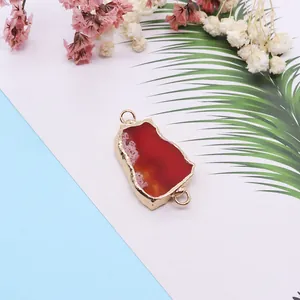 Irregular natural red agate slice pendant with gold plated edges and double loops