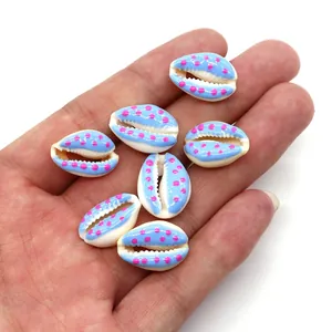 Close-up of blue shell beads with pink polka dots for DIY jewelry making and necklaces