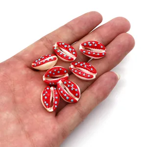 Macro detail of red and blue polka dot cowrie shell beads for DIY jewelry making
