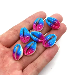 Macro view of gradient blue and pink natural cowrie shell beads for DIY jewelry making