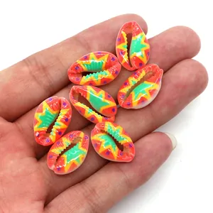 Close-up of hand-painted natural cowrie shell beads with colorful floral bohemian patterns