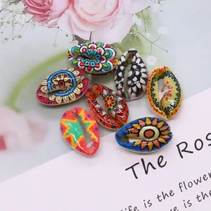 Set of seven colorful painted natural conch shells with bohemian floral patterns for DIY