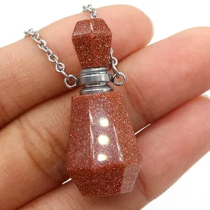 Macro shot of Goldstone perfume bottle pendant necklace with glittering metallic luster