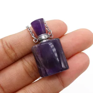 Close-up of a natural amethyst perfume bottle pendant with silver metal chain details