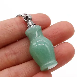 Macro detail of a small green aventurine perfume bottle pendant on a thin silver chain