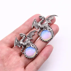 Macro view of vintage silver dragon pendant with iridescent opal gemstone detailing