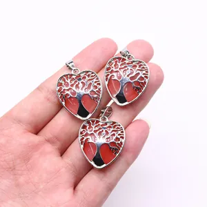 Close-up of heart-shaped Life Tree pendants with red natural stone and silver alloy detail