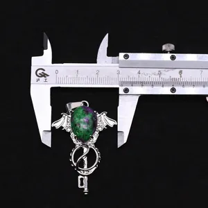 Macro view of crystal scepter pendant measuring 3.2cm width with metal calipers