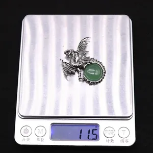 Detailed view of vintage silver dragon pendant with green stone weighing 11.5g
