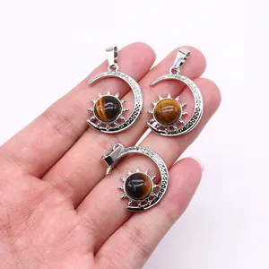 Three-piece silver sun and moon tiger eye pendants shown held against a white background