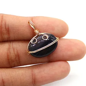 Macro shot of handmade gold wire-wrapped oval striped agate pendant for DIY necklace