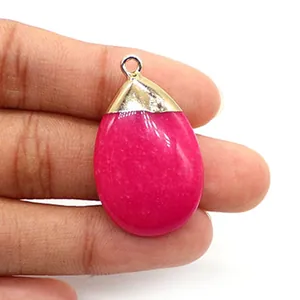 Macro shot of rose pink teardrop stone pendant with gold plated bail for DIY necklaces