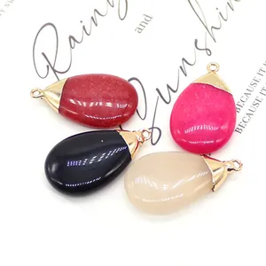 Set of four polished teardrop stone pendants in red, pink, black and cream with gold caps