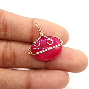 Detailed view of handmade rose red agate pendant wrapped in delicate gold wire mesh