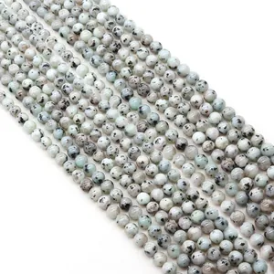 Natural spotted round stone beads for DIY jewelry making displayed in parallel rows