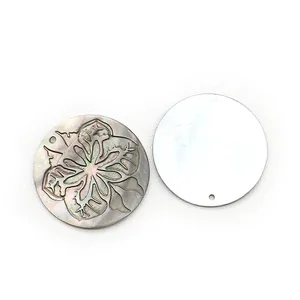 Natural black shell round pendant with engraved hibiscus flower and iridescent luster finish