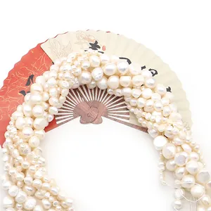 Natural white freshwater pearls for DIY jewelry displayed with elegant paper fans