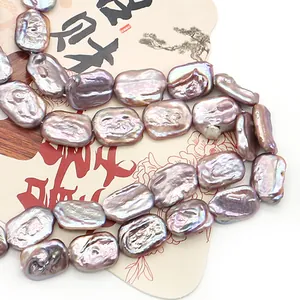 Lustrous purple baroque freshwater pearls displayed on an artistic traditional paper fan