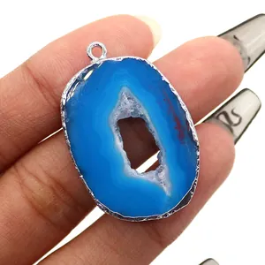 Detailed view of blue agate slice pendant with silver electroplated edges and geode center