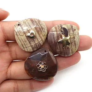 Detail of natural stone teardrop pendants with gold heart, star and flower metal accents