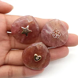 Macro detail of teardrop natural stone pendants with inlaid star, rose, and heart metal charms