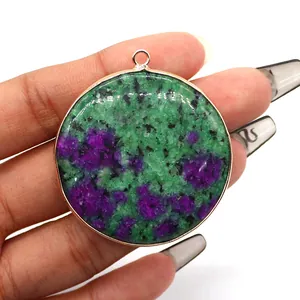 Macro shot of Ruby in Zoisite round gemstone pendant with golden plated metal border