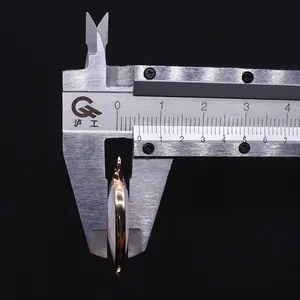 Measuring the thickness of white agate oval pendant connector with silver calipers
