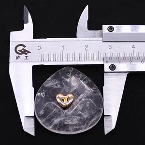 Macro view showing a water-drop crystal pendant width of 2.6cm with a gold heart inlay