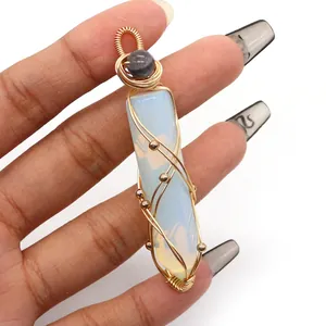 Detailed wire-wrapped crystal pendant with white gemstone and golden beads decoration