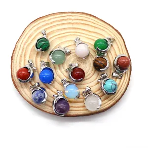 Natural gemstone dolphin pendant collection featuring various crystal beads on wood base