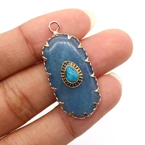 Macro detail of oval natural stone pendant with evil eye design and silver metallic edging
