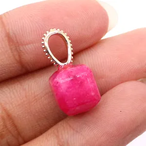 Macro detail of square cut rose red natural stone pendant with decorative metal bail