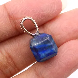 Macro detail of cube-shaped lapis lazuli pendant with silver bead textured bail