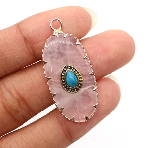 Macro view of oval pink natural stone pendant with blue turquoise inlay and golden frame