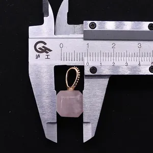 Macro shot of rose quartz cube pendant measuring 15mm with a gold beaded bail