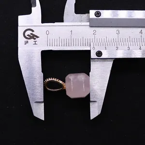 Macro shot showing 10mm rose quartz square pendant measured with a digital caliper