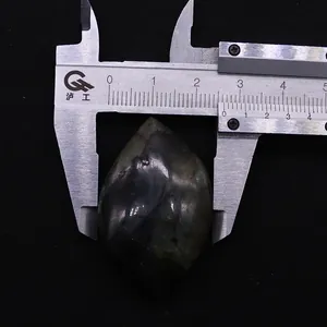 Macro view of 27mm marquise labradorite stone measured with a professional caliper