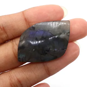 Macro view of polished leaf-shaped labradorite stone with blue iridescent flash detail