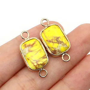 Macro shot of rectangular yellow imperial stone connector with gold plating for jewelry DIY