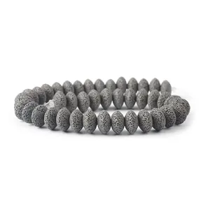 Close-up of porous dark gray volcanic stone beads for DIY jewelry making and crafting