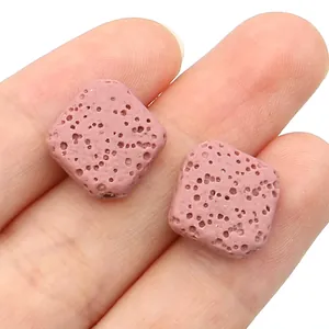 Macro detail of light pink square lava stone beads for DIY jewelry with porous texture