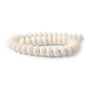 Close-up of white volcanic lava stone disc beads for DIY jewelry making accessories