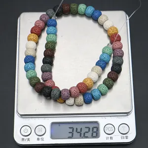 Macro shot of colorful natural lava rock beads weighing 34.28g on a digital jewelry scale