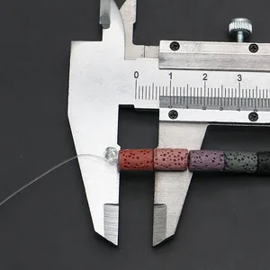Measuring cylindrical colorful lava stone beads with a metal caliper for jewelry making