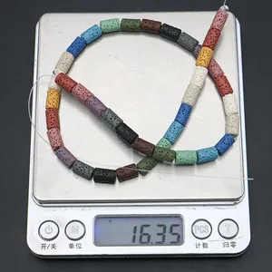 Macro shot of 16.35g multi-colored cylindrical lava stone beads on a scale for jewelry DIY