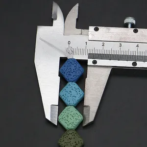 Macro view measuring 10mm colorful volcanic lava beads with a metal vernier caliper