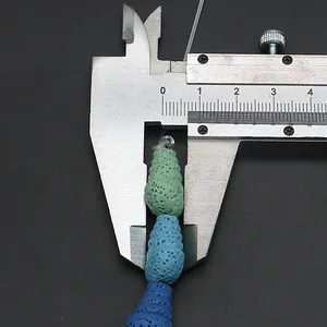 Macro shot measuring 8-9mm conch-shaped volcanic stone beads with porous texture