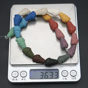 Close-up of colorful cone-shaped lava stone beads on a scale weighing 36.33 grams
