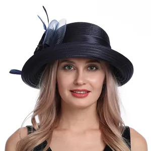 Detail of elegant navy mesh flower sun hat with feather accents on a female model